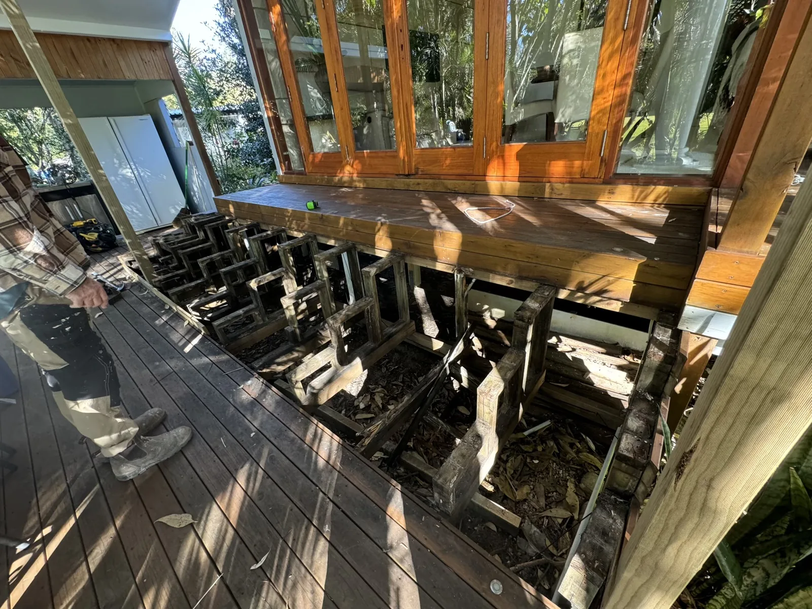 Existing deteriorated deck stair framing before rebuild