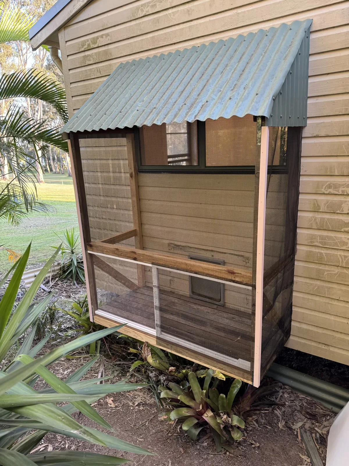 Finished screened outdoor enclosure with corrugated roof