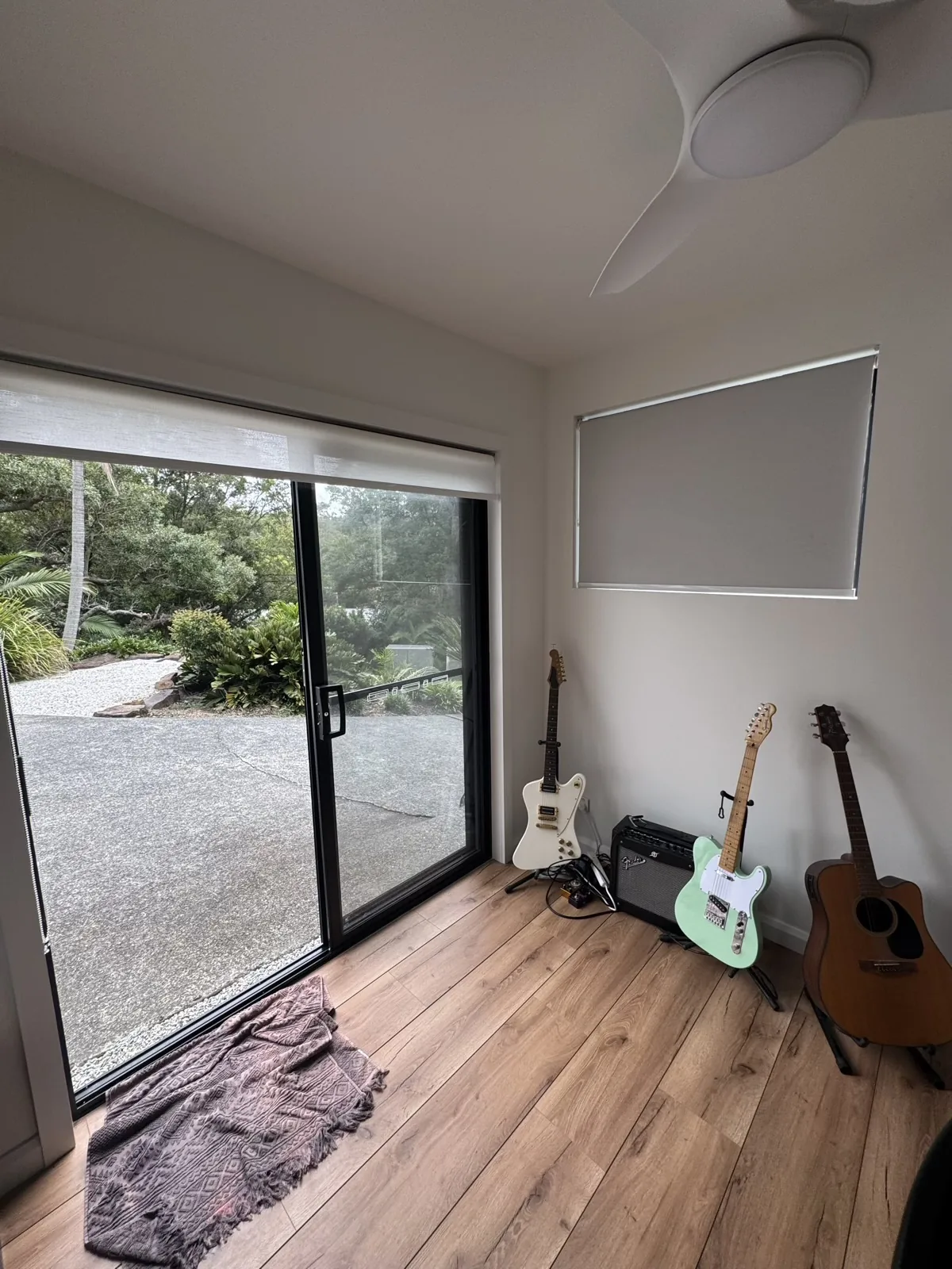 Finished bright home studio with timber flooring and black sliding door
